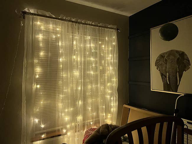 reviewer image of the warm white curtain lights hanging from window