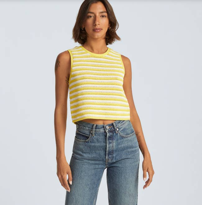 model wearing the yellow and white striped top with jeans