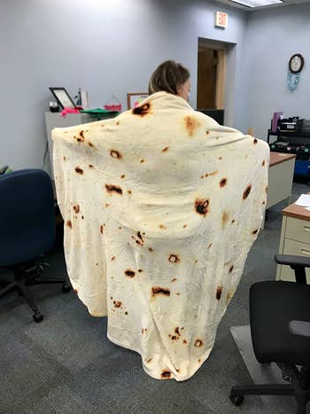 image of reviewer standing holding up the tortilla blanket