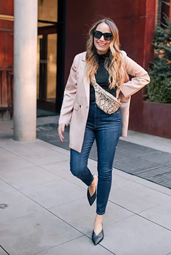 a model wearing the fanny pack in snake print