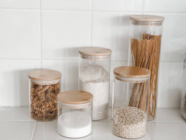 reviewer's five glass containers on the counter holding pasta, salt, flour, and rice