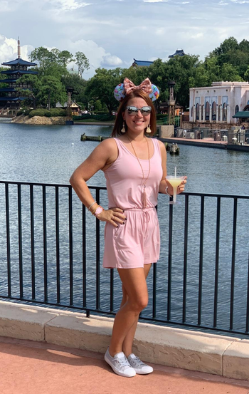 a reviewer wearing the romper in light pink