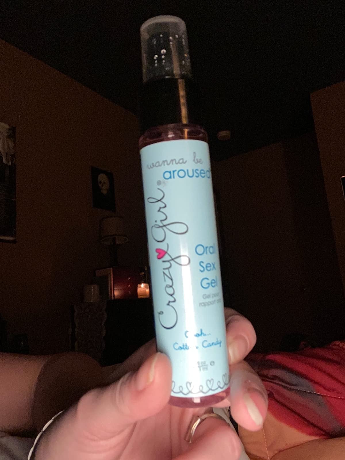 Reviewer holding bottle of cotton candy oral sex gel