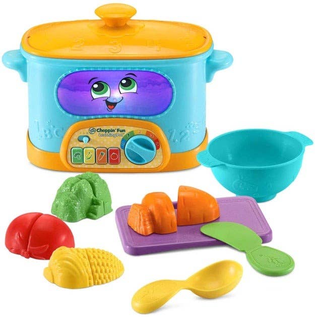 the learning crock pot with toy vegetables and dishes