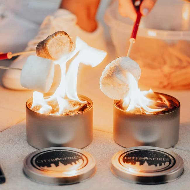 Three marshmallows being roasted over two of these portable fires
