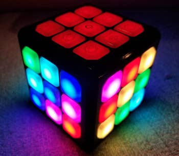 A reviewer image of the cube lit up in a ton of colors 