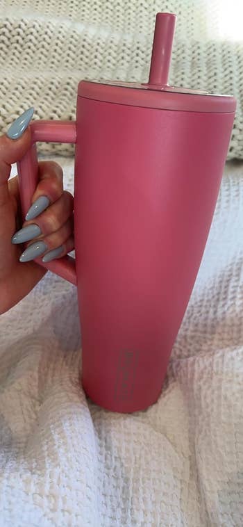 reviewer holding pink tumbler