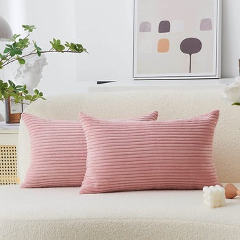 The pillow covers in pink in rectangle shape 