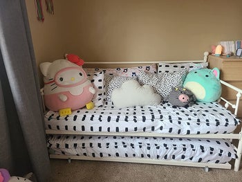 reviewer photo of trundle bed with stuffed animals on it