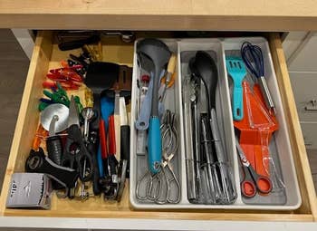 Organized kitchen drawer with various utensils like spatulas, whisks, and measuring spoons before using the dividers