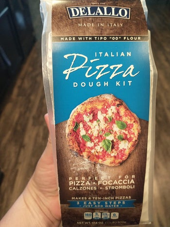 hand holding pizza dough package