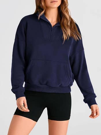 Person wearing a casual zip-up pullover sweater and shorts, suitable for a relaxed, comfy  style