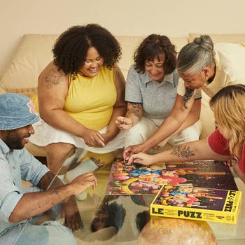 a group of people working on a puzzle
