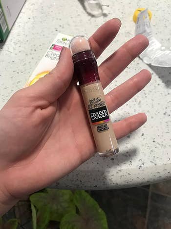 Reviewer holding the concealer