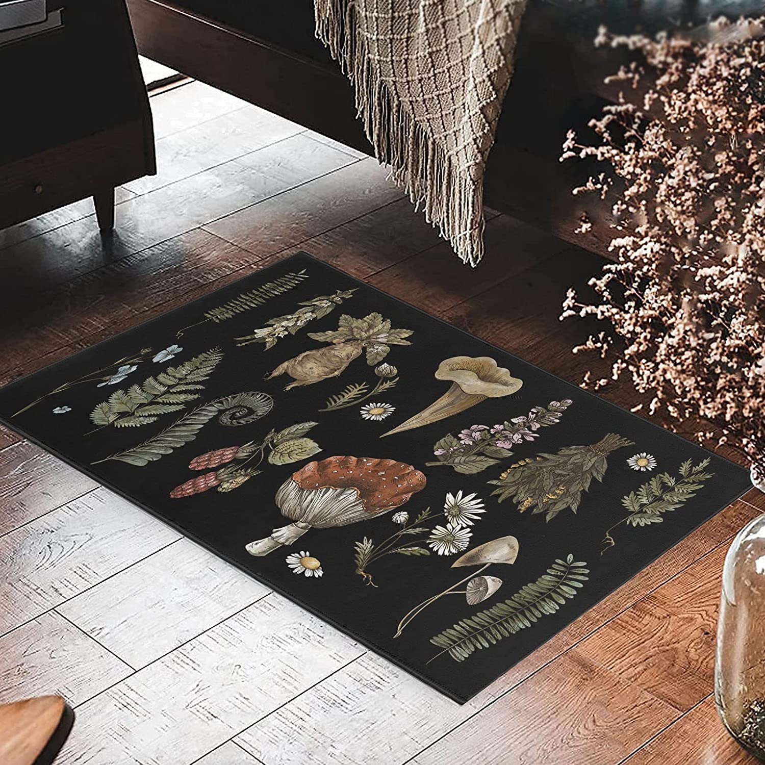 black doormat beside bed with wildflower and mushrooms on it
