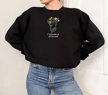 model wearing the same sweatshirt in black