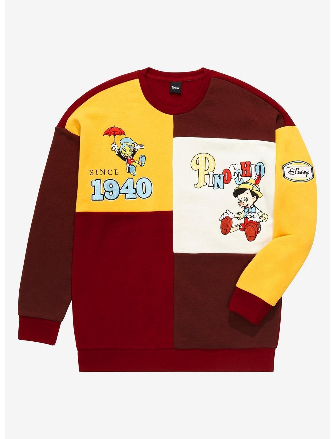 a color block sweatshirt with yellows, reds, and whites and pinocchio and jiminy cricket on it