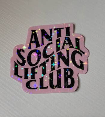 pink glittery sticker that says 