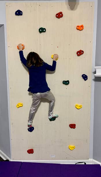 reviewer image of a child climbing the wall set