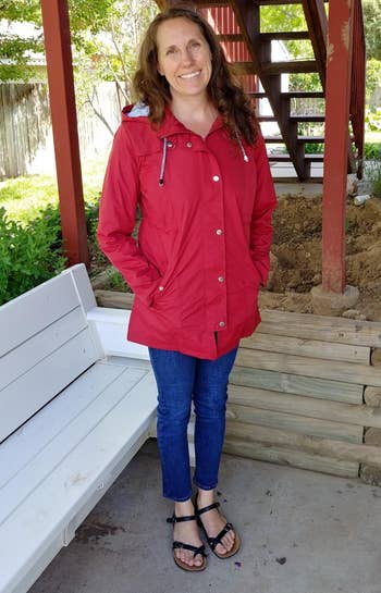 reviewer wearing a red rain jacket