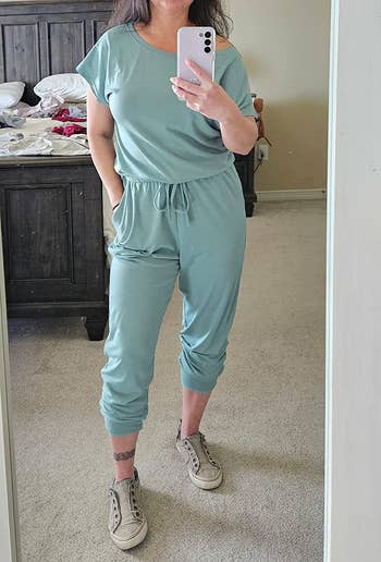 a reviewer wearing the jumpsuit in light blue 