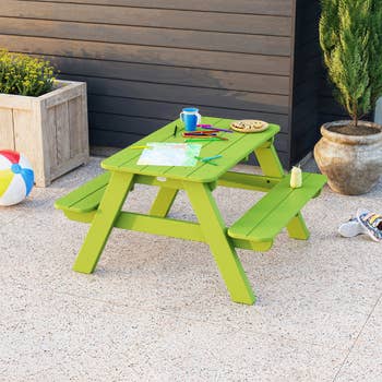 Children's picnic array  connected  a patio, with trade  supplies and snacks, adjacent  to a planter and a formation  ball