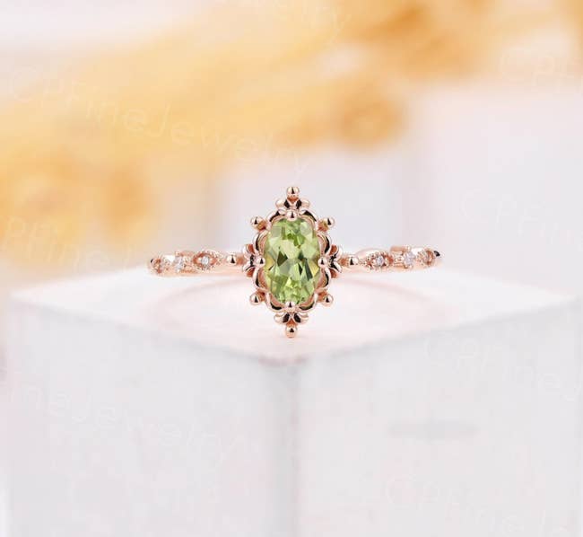 The green peridot ring in an oval shape with a rose gold band