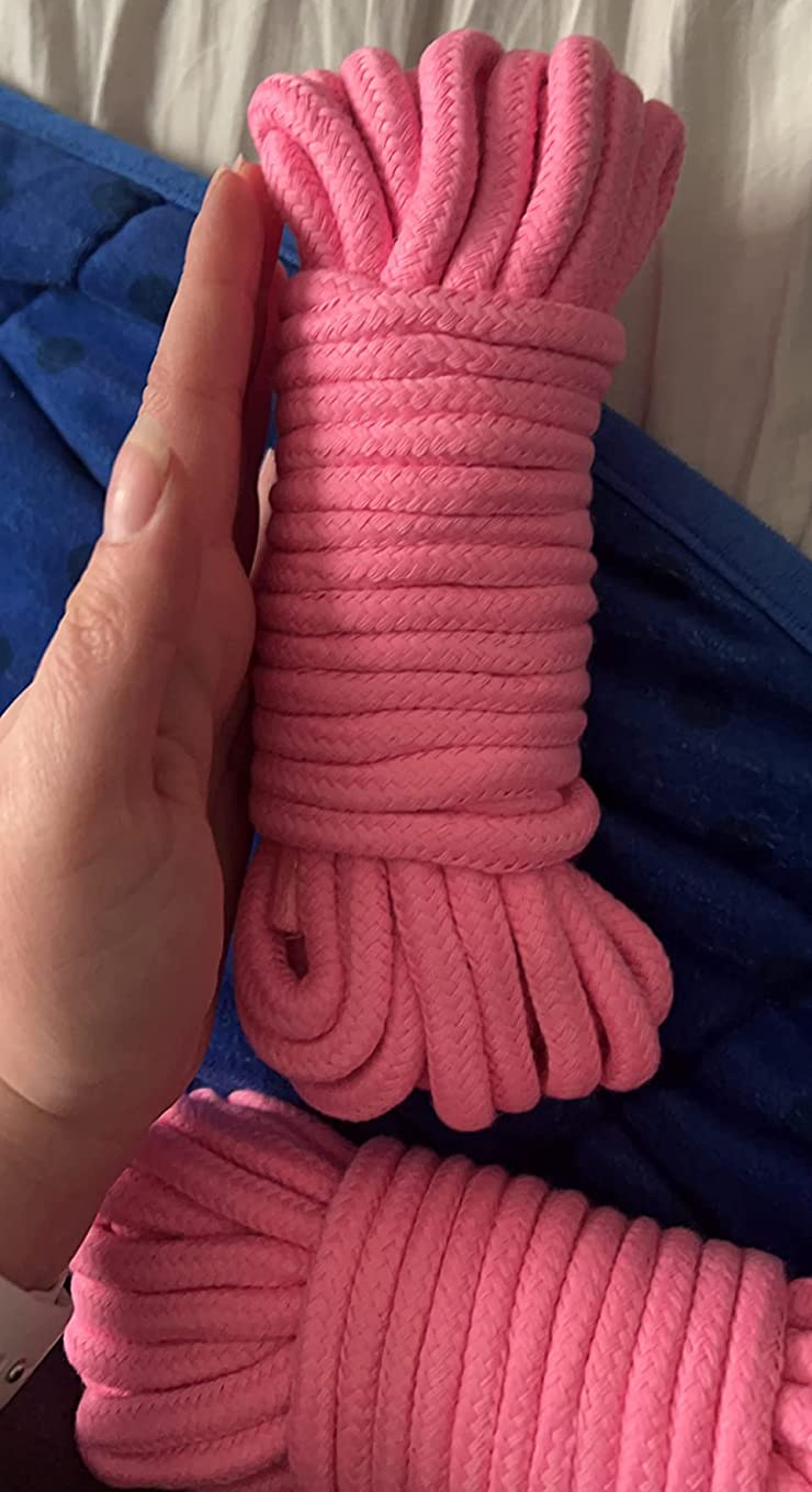 Reviewer with hand next to two bundles of pink rope