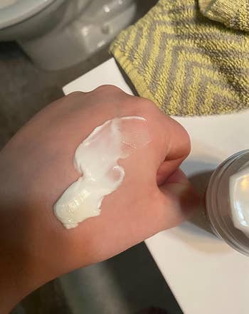 image of a dollop of eye cream on the back of a reviewer's hand