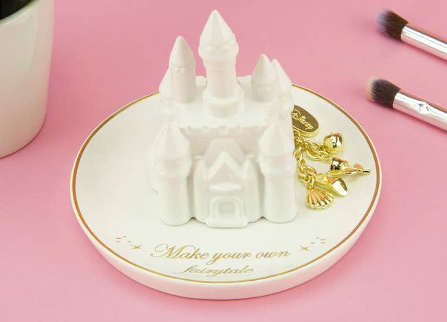 a porcelain trinket dish with a castle in the middle