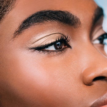 close up of model wearing a shimmery gold eyeshadow on their lids