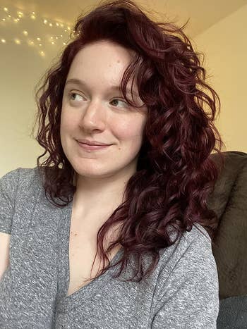 reviewer with soft looking curly hair