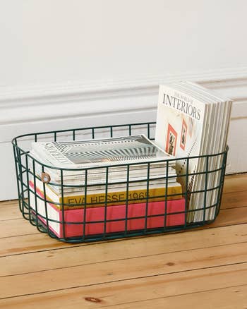 Large navy wire basket with magazines and books inside