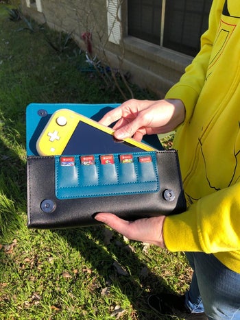 a switch inside the snorlax case, showing the five game card slots as well