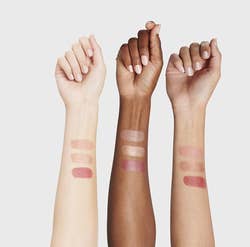 three models' arms showing swatches of the different colors