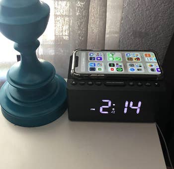reviewer image of the clock close up showing how a phone can wireless charge on top