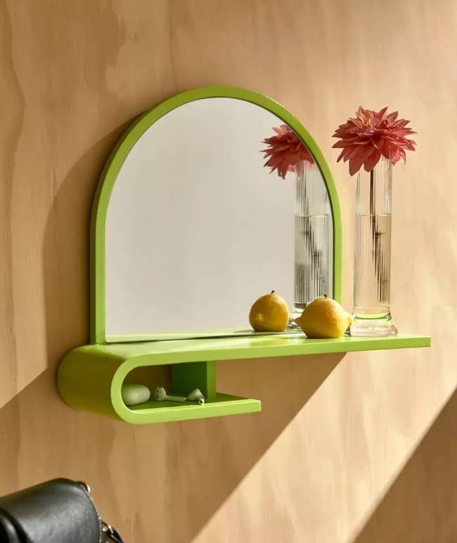 the lime green maura entryway mirror shelf mounted to a wall