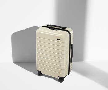 Hard-shell suitcase in cream color
