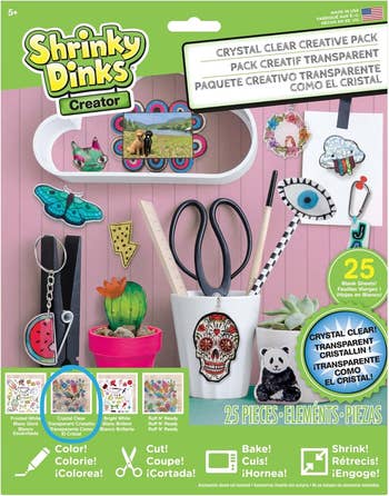 Cover of a Shrinky Dinks Creator kit showing crafting items and accessories. It includes 25 pieces for originative  activities for ages 5 and up