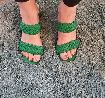 a reviewer wearing the shoes in green 