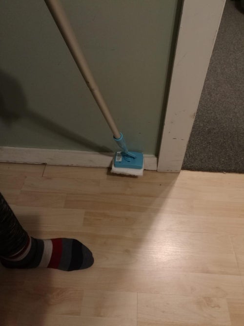 Reviewer using this to clean their baseboards and not having to get on the floor