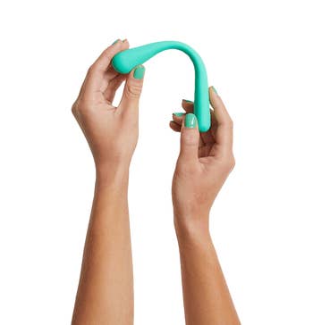 hands bending the green vibrator