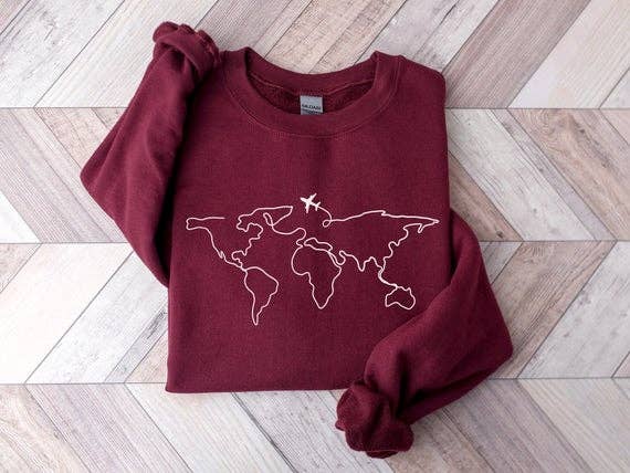 maroon sweatshirt with graphic of world map and plane flying on front