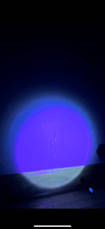 a black light showing a stain on the wall