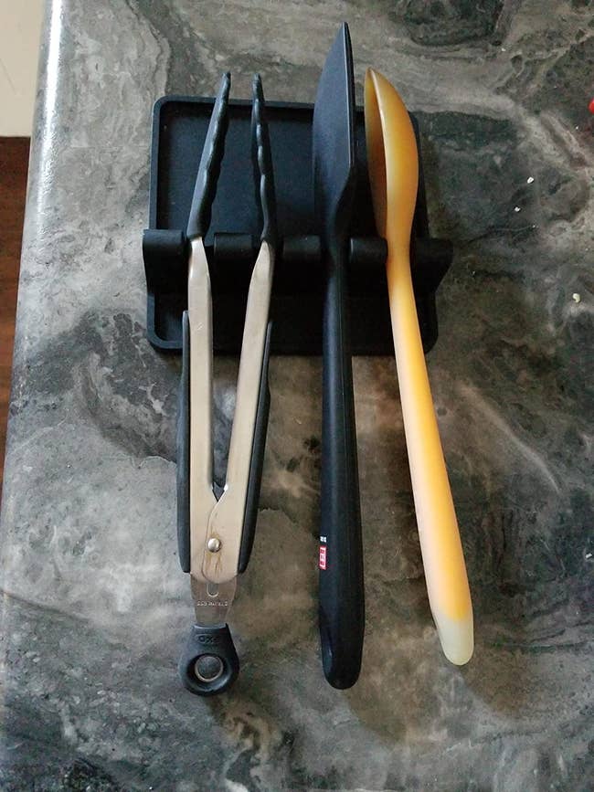 reviewer's utensil rest holding tongs, a serving spoon and a spatula