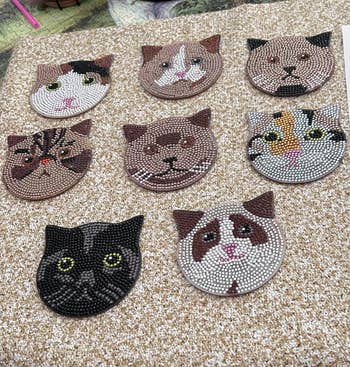 DIamond painted coasters in the shape of cat faces 