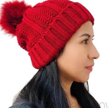 model wearing red satin-lined winter hat