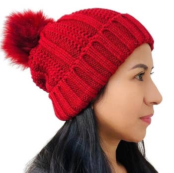 model wearing red satin-lined winter hat