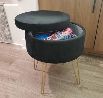 reviewers opened black ottoman with gold legs 