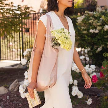 model walking with the light pink tote bag over their shoulder